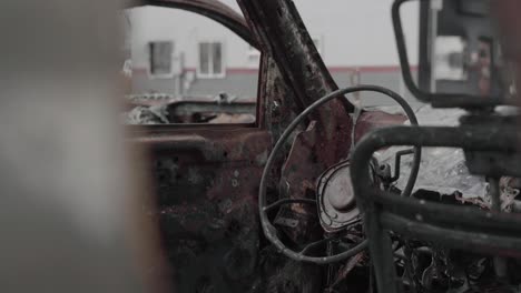 metal frame of a steering wheel is all that is left in the aftermath a blazing wildfire - 4k