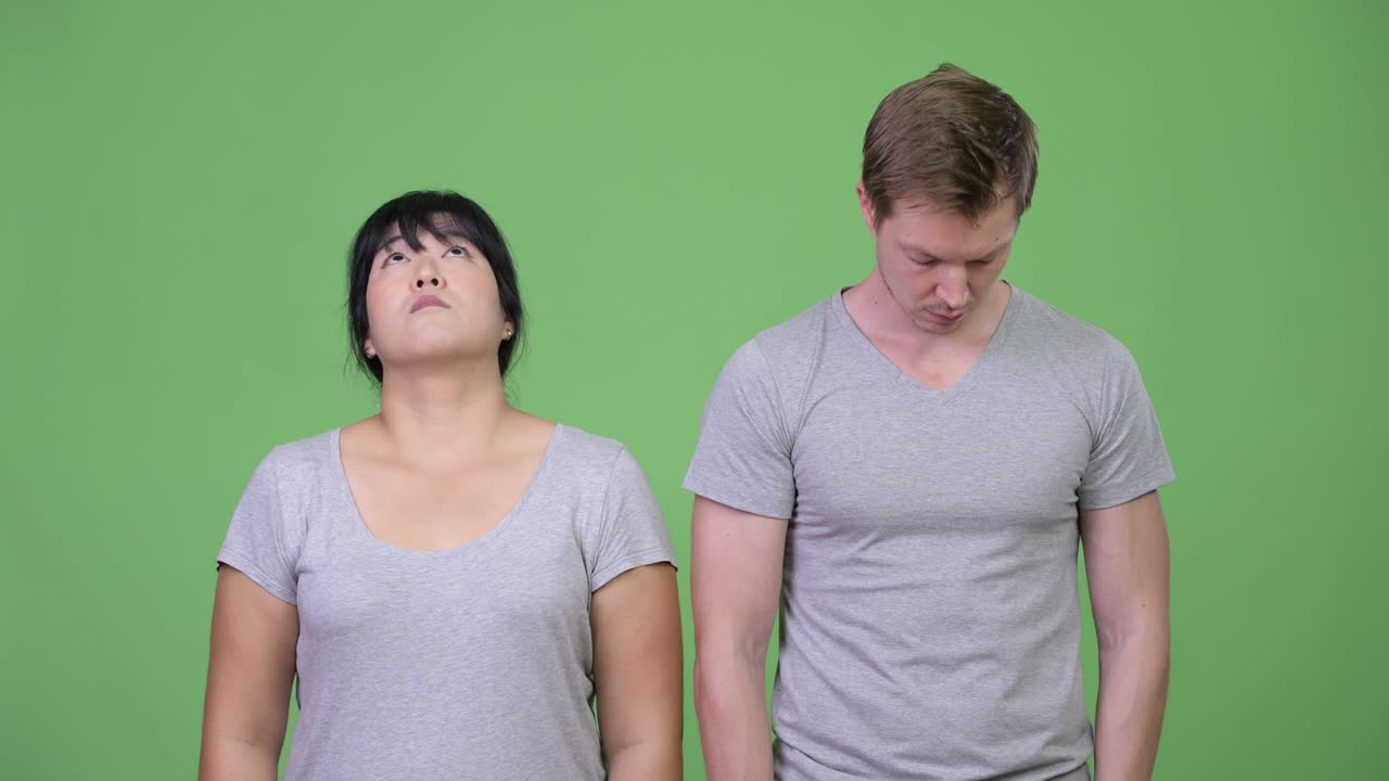 Young multi-ethnic couple looking at opposite directions together