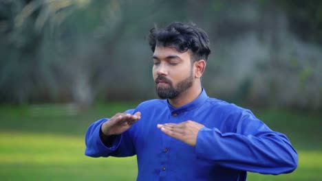 Indian-man-doing-breathe-in-breathe-out-yoga-exercise