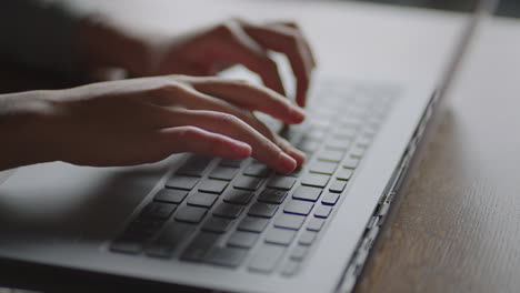 Close-up-young-woman-typing-on-the-keyboard-of-a-laptop-sitting-at-home.-Remote-work-from-home.-Home-Office