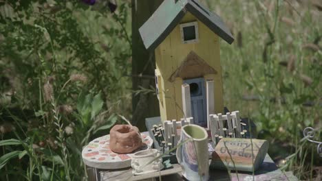 a-small-table-with-a-small-bird-feeder