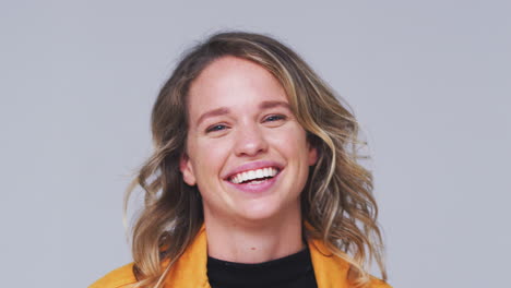 Studio-Shot-Of-Woman-Appearing-From-Bottom-Of-Frame-Laughing-At-Camera-In-Slow-Motion