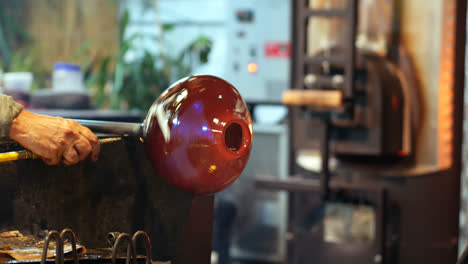 two glassblower shaping a molten glass