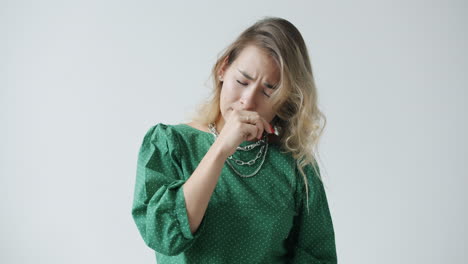 woman covering her mouth in disgust