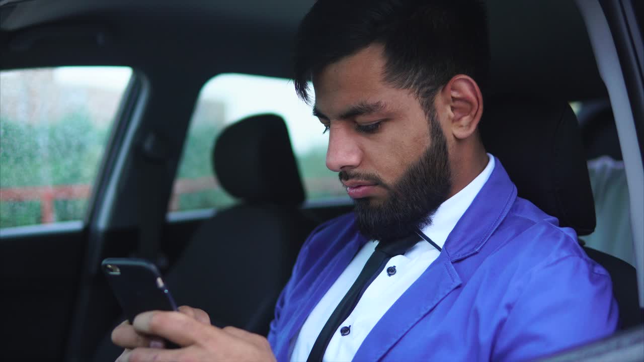 Man Texting on Smartphone in a Car