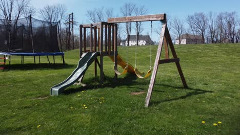 kids swingset in green grass