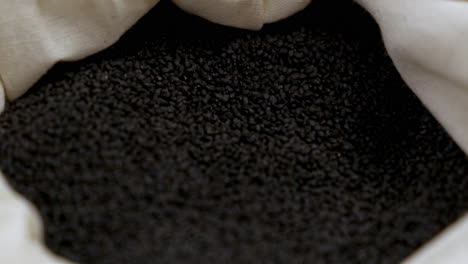 full bag of black basil seeds, close-up shallow focus