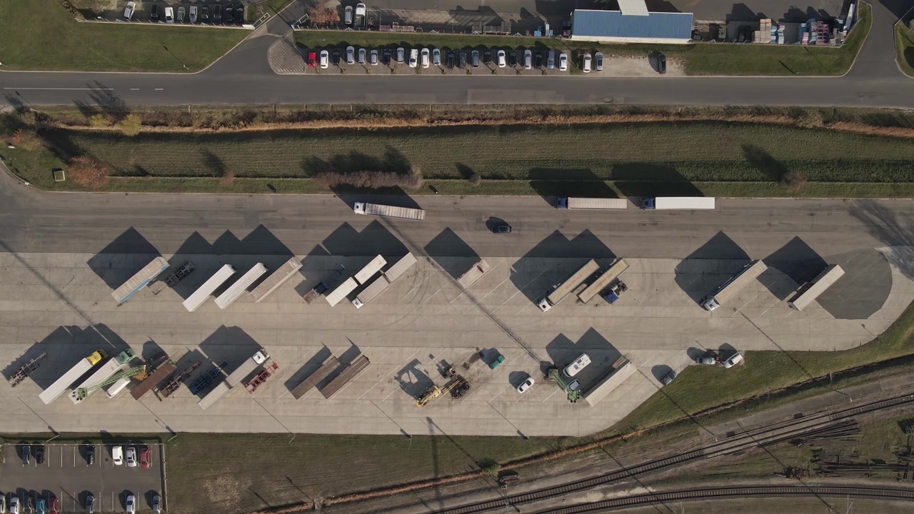 Aerial footage of logistics and freight transport hub with a moving truck.