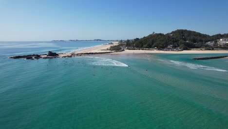 surfers on blue waters of currumbin alley near palm beach in gold coast, queensland australia