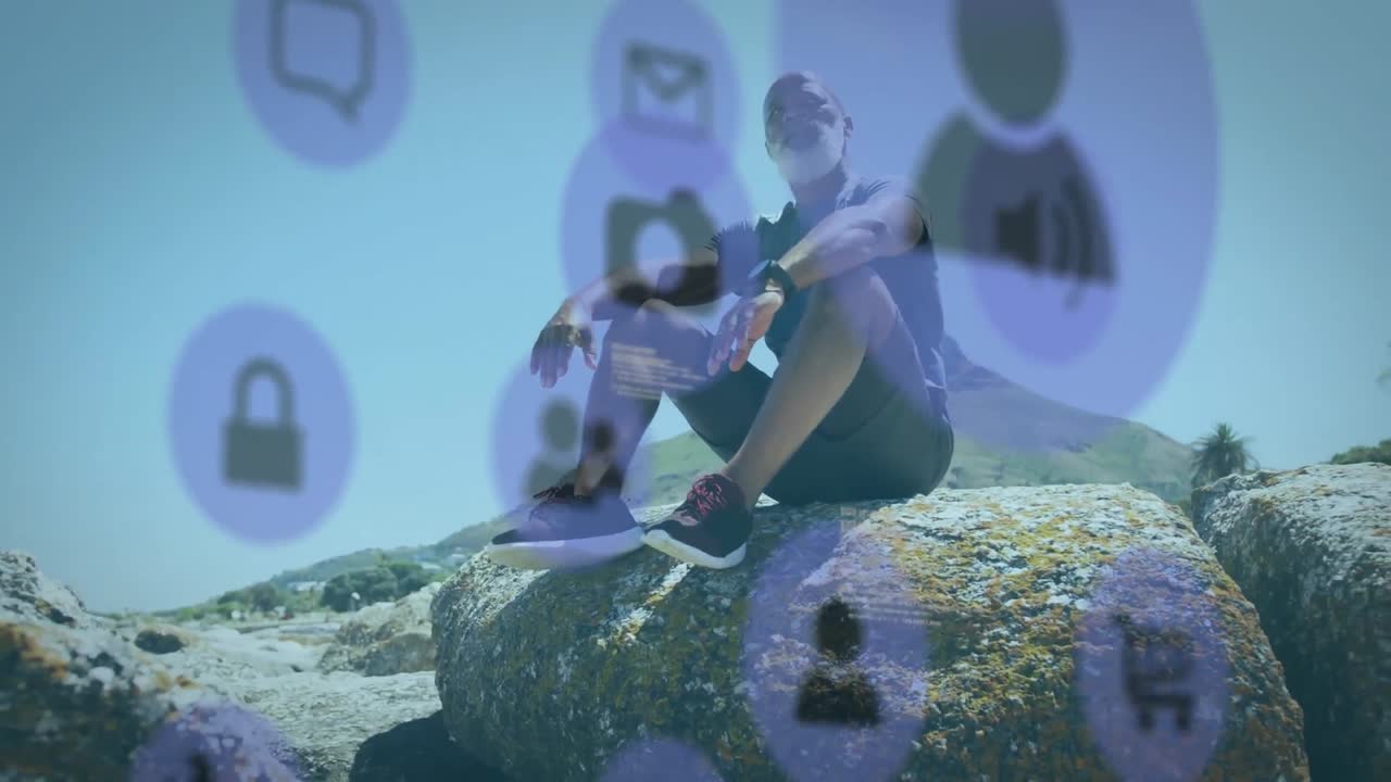 animación de la red de conexiones sobre un hombre afroamericano mayor sentado en rocas en la playa