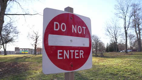 car and vehicle sign discouraging entrance one way road in outdoor setting