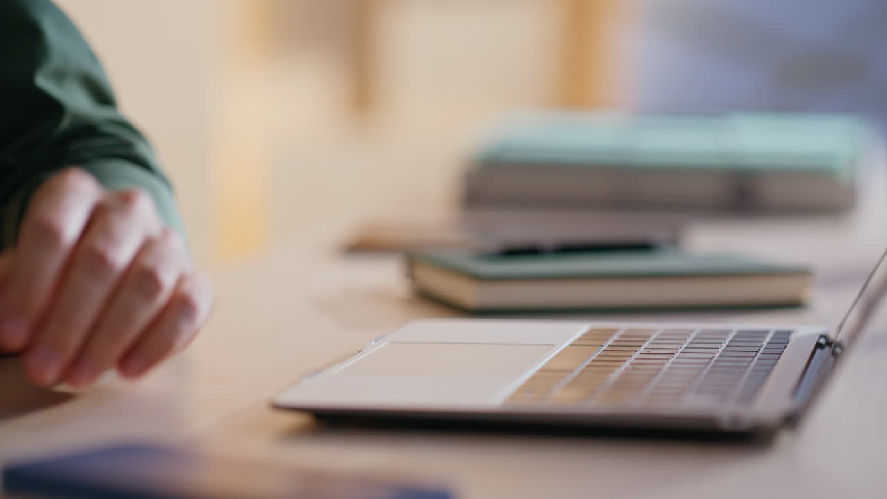 Close-up of Hands Using a Laptop