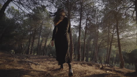 fashion model in black walk of fame entering woods spain