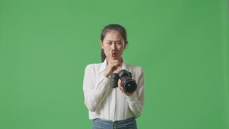 woman with camera, green screen