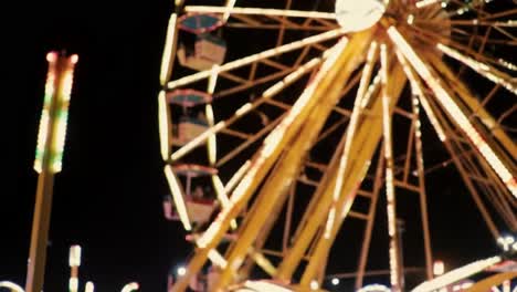 a vibrant nighttime scene featuring a luminous ferris wheel, illuminating the fairground with colorful lights and creating a joyous atmosphere for visitors