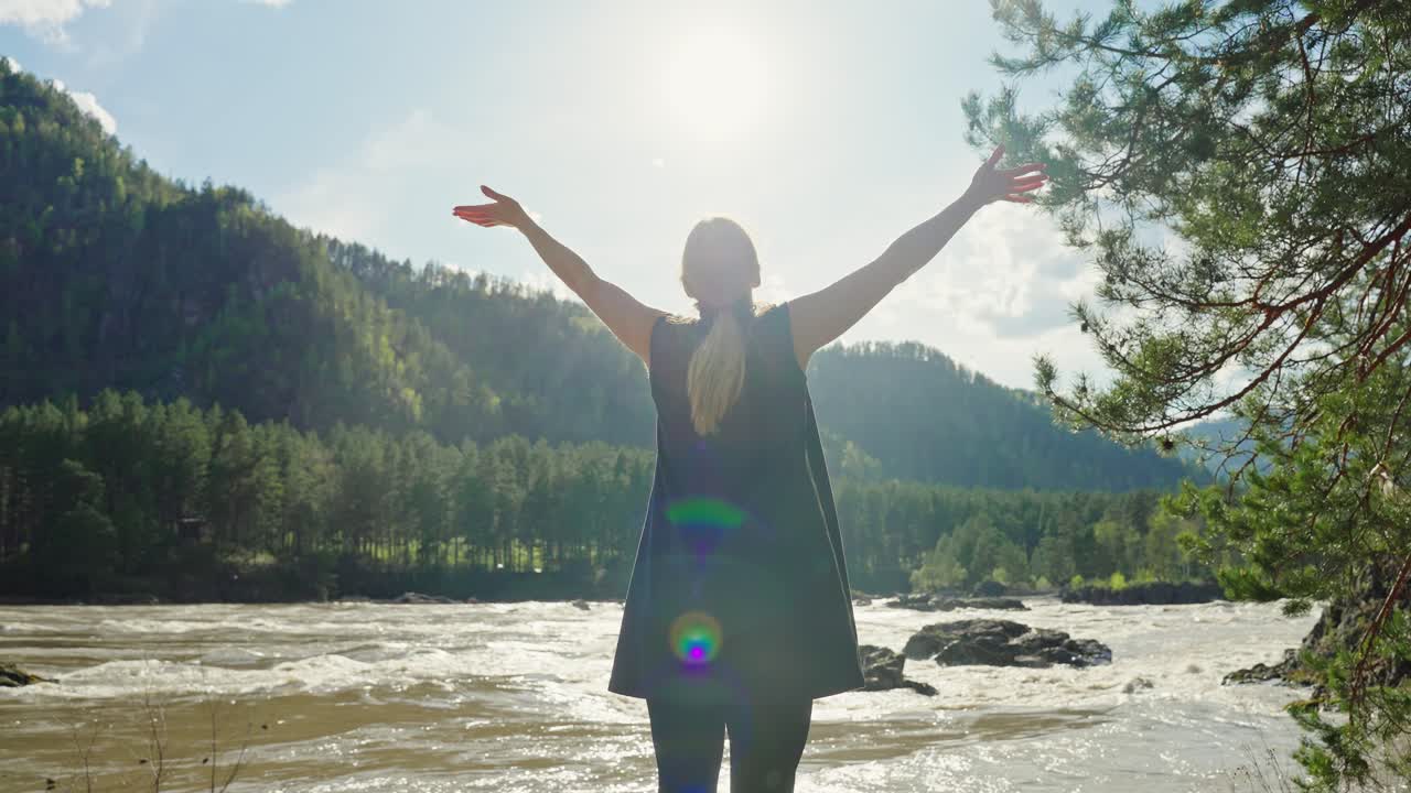 Woman enjoying nature with arms up