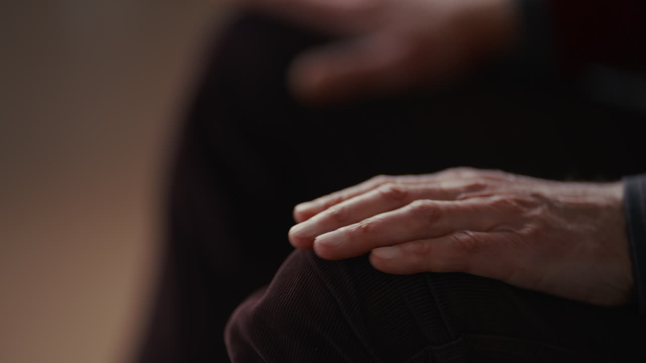 Close-up of a Person's Hand Resting on Their Knee