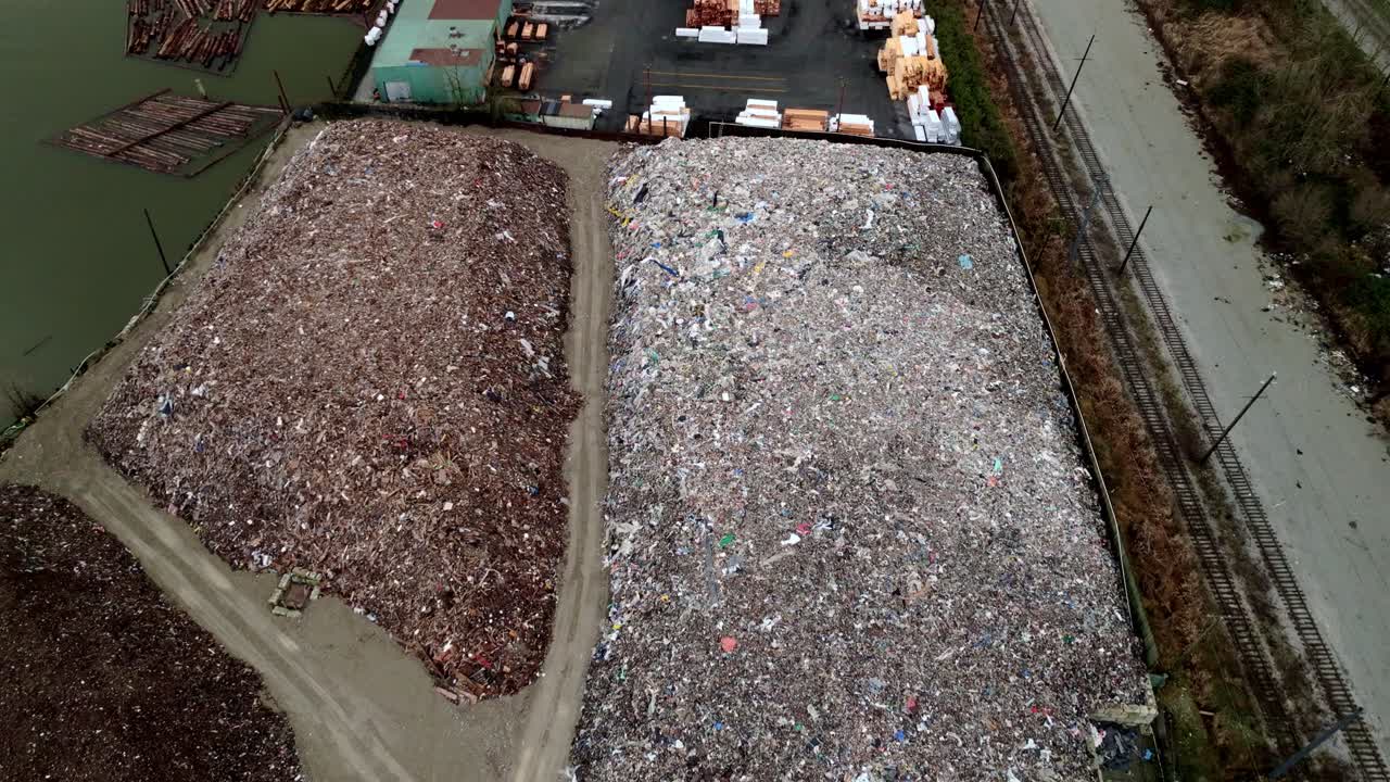 Huge Waste Stockpiles At Recycling Transfer Station In Vancouver, Canada. aerial shot