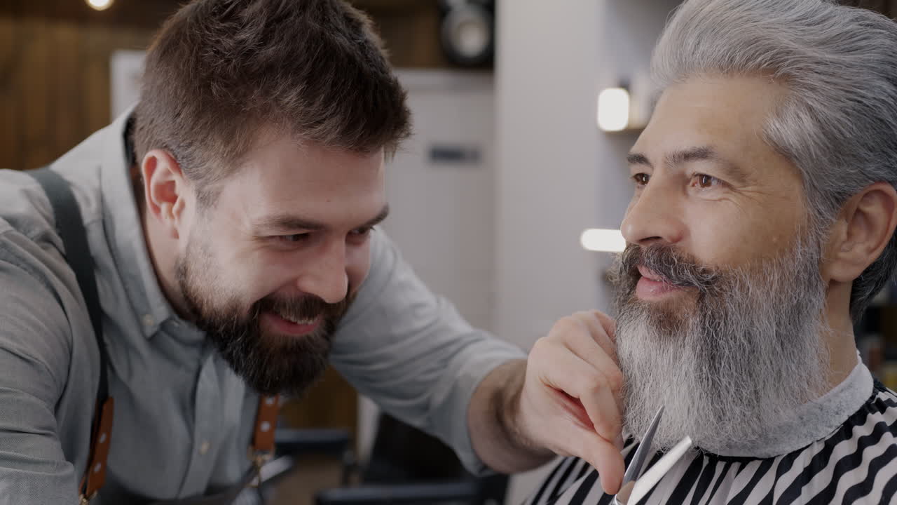Barber Trimming a Senior Man's Beard