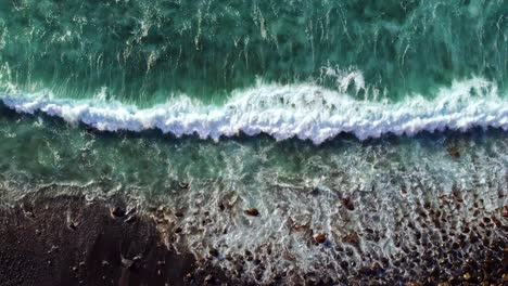 turquoise waves on beach top down 4k aerial shot from tenerife