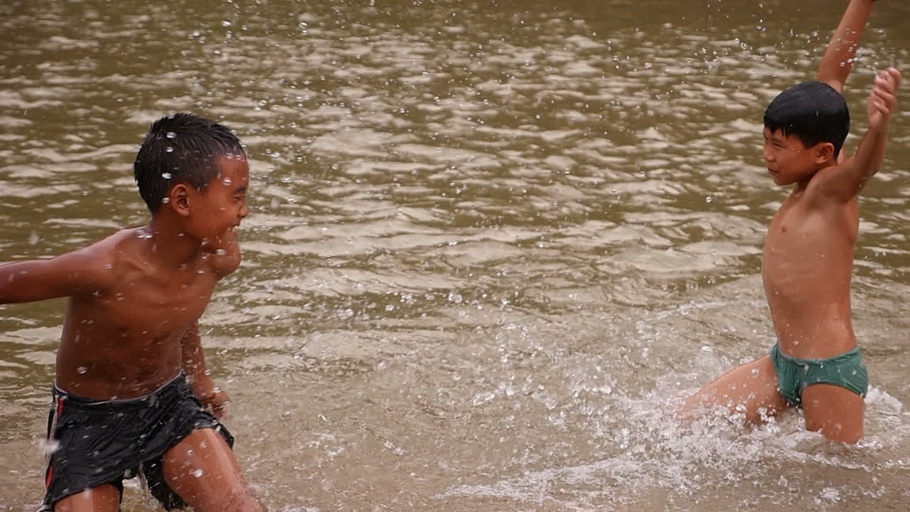 Boys Splashing in a River
