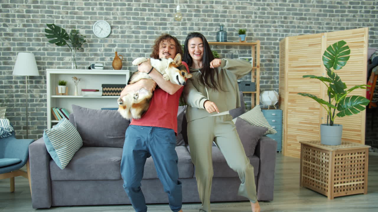 Couple Dancing with a Dog in Living Room