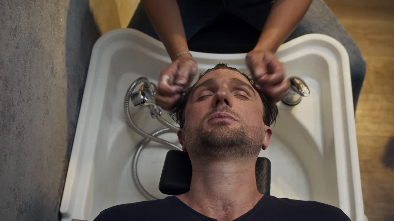 Man getting his hair washed at a salon