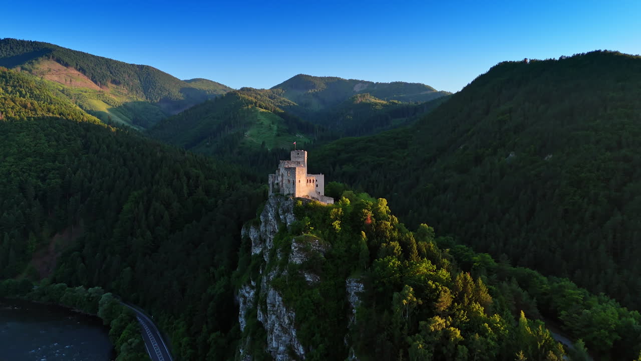 Beautiful castle located on the mountain top over the river. Mighty verdant mountains at backdrop. Strecno Castle, northern Slovakia. Aerial view.