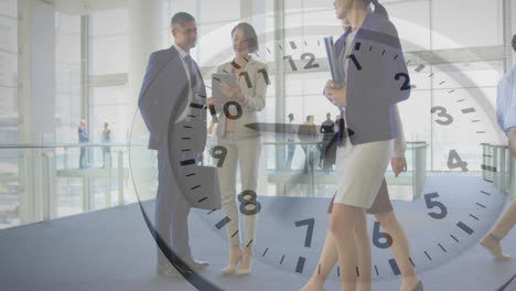conversing in office, business professionals with clock animation overlay on screen