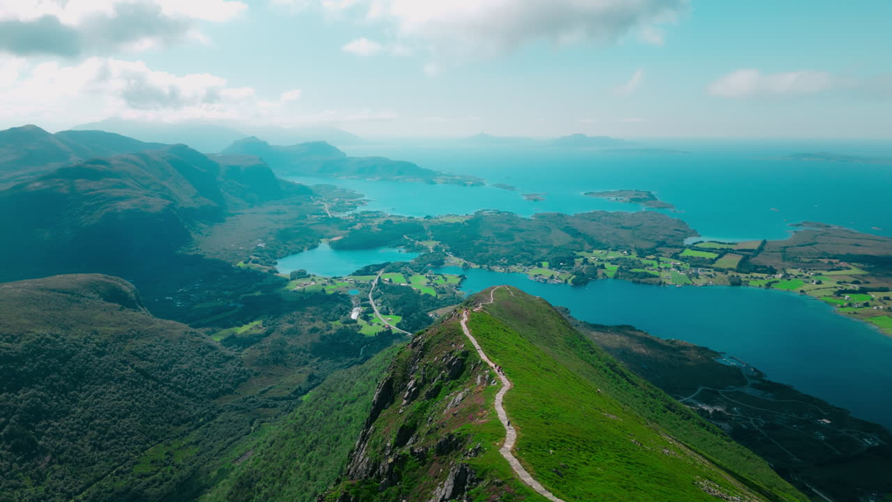 Aerial orbiting shot of hikers walking at the Midsundtrappene in Norway