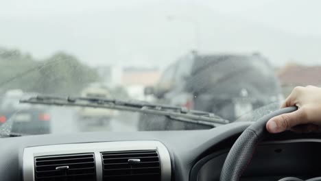 Hand-of-driver-on-car-wheel