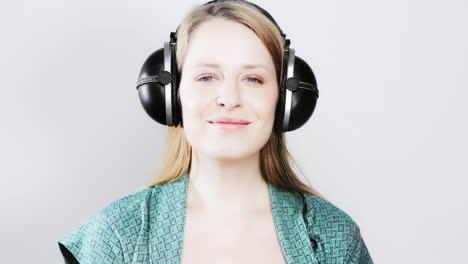cool female dancer with changing retro headphones to listen to music