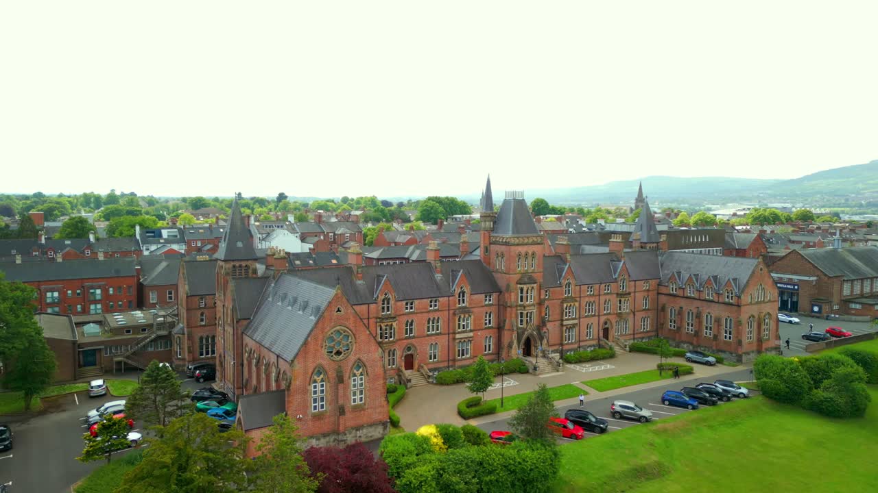 Wide to close-up aerial video of Methodist College Belfast, in Northern Ireland, UK on a bright and sunny day. Filmed in 4K, 60FPS and with Rec709 color.
