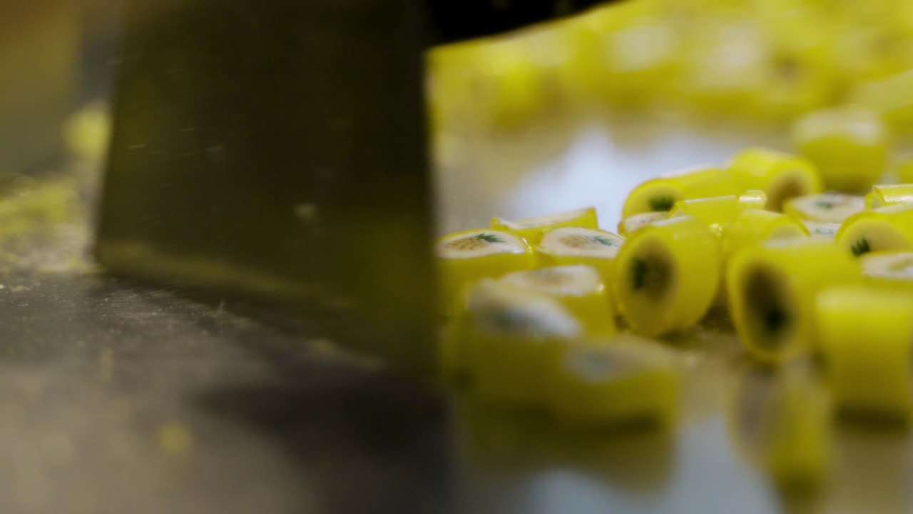 Sweet yellow caramel candies bouncing and falling in slow motion