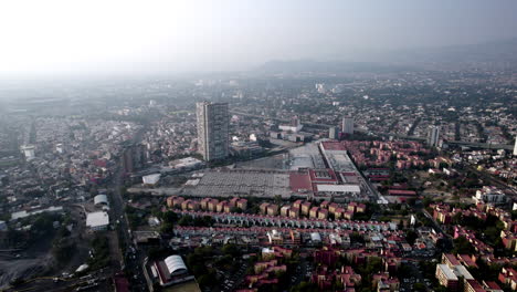 drone view of a shopping center and a neighborhood in mexico city during a very polluted day