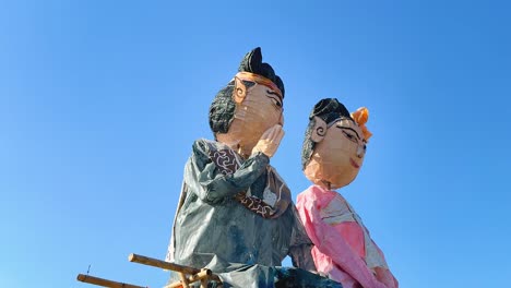 colorful puppets against a clear blue sky