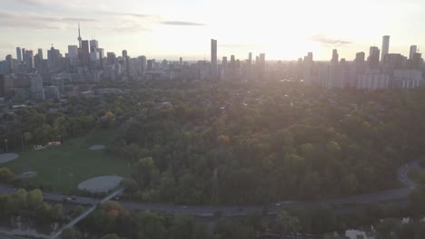 aerial drone shot of toronto skyline while camera moves backward showing highway