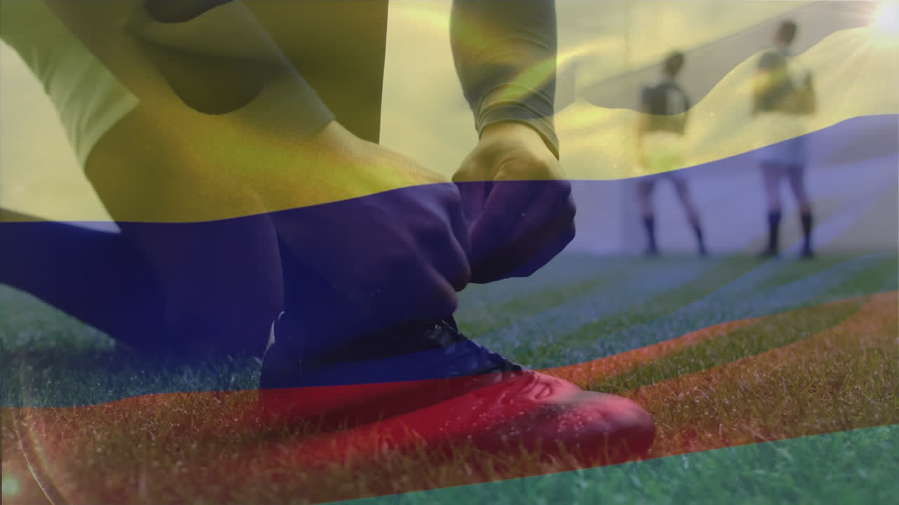 animación de la bandera colombiana ondeando sobre un jugador de rugby masculino biracial atando un zapato