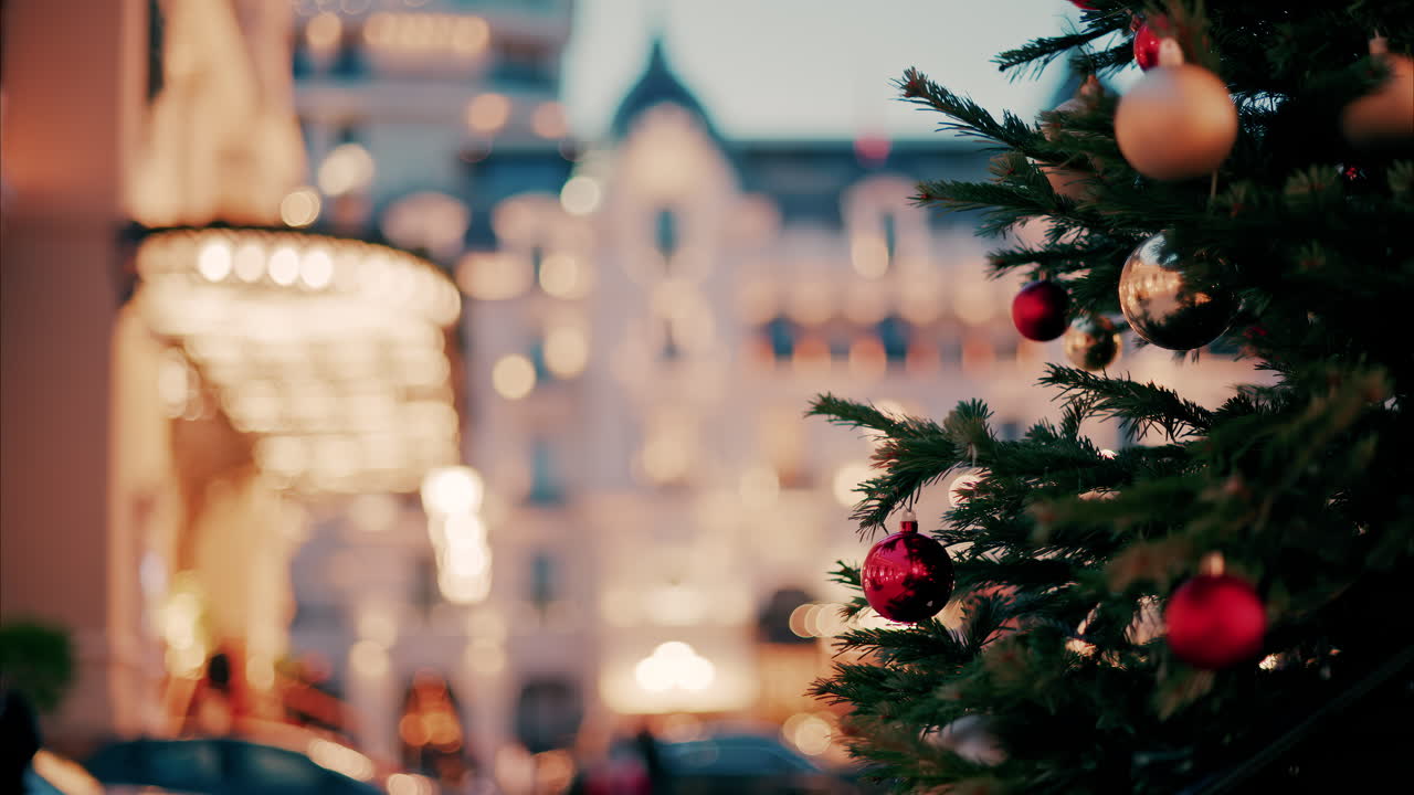 Close up of decorations on a Christmas tree in front of the Monte Carlo Casino in Monaco in the evening
