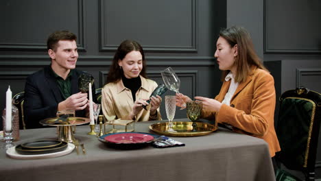 Asian-woman-talking-with-a-couple-sitting-at-a-table