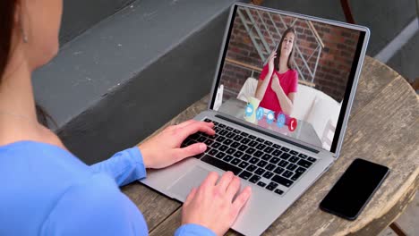 caucasian woman using laptop on video call with female colleague working from home