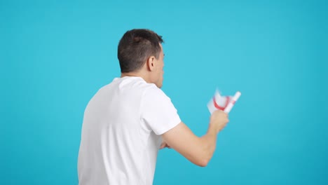 Rear view of a man waving a english pennant