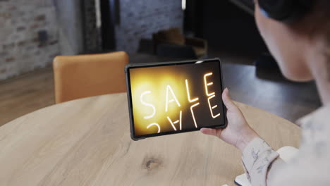 Biracial-woman-using-tablet-at-cafe-for-online-shopping,-slow-motion