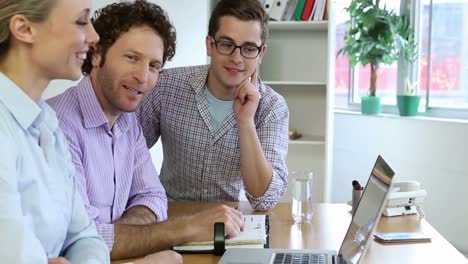 happy business team using laptop and planning