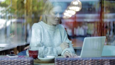 woman typing on laptop