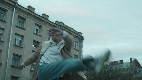 energetic male dancer dancing outdoors