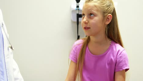 female doctor interacting with a sick girl