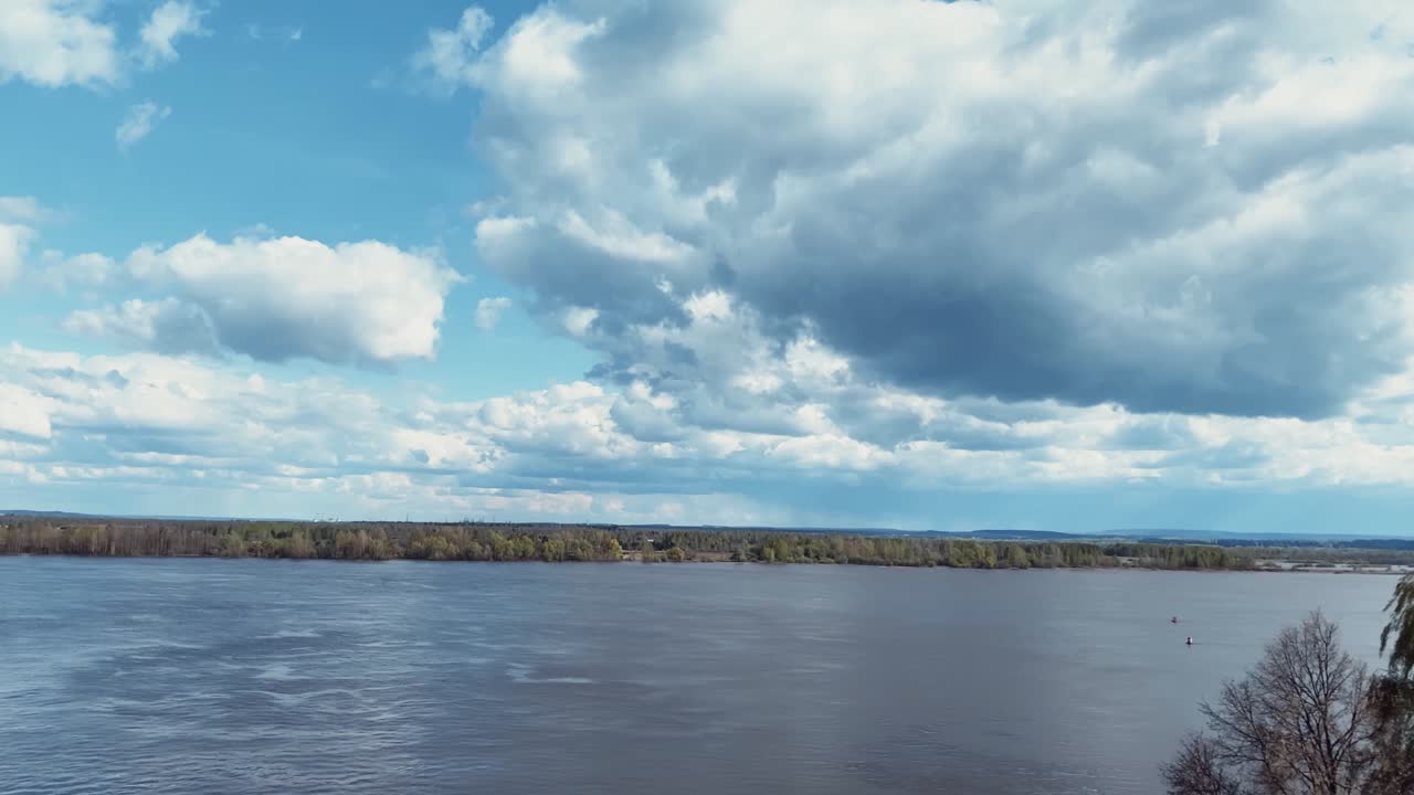 River landscape with clouds moving on blue sky. Time lapse. Summer day.
