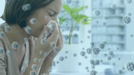 animation of macro covid-19 cells floating over caucasian woman sneezing into a tissue