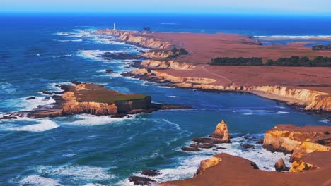 aerial view of dramatic coastline with lighthouse